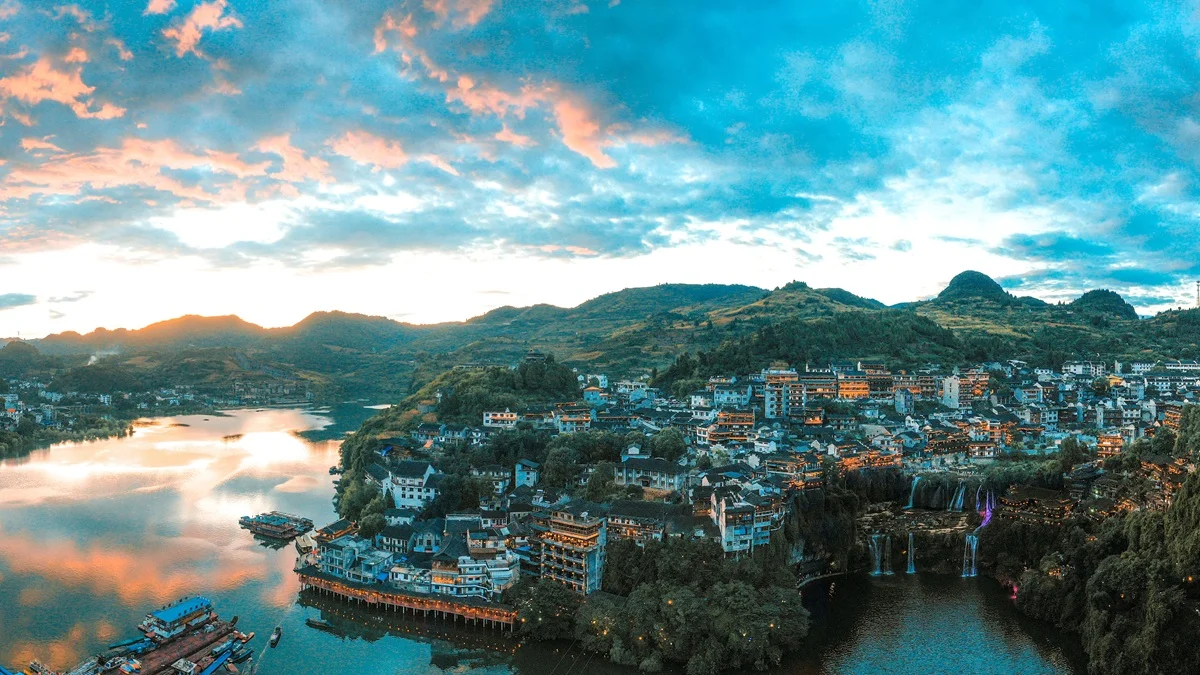 Panoramic view of Furong Ancient Town river waterfall and Tujia stilt houses in daytime