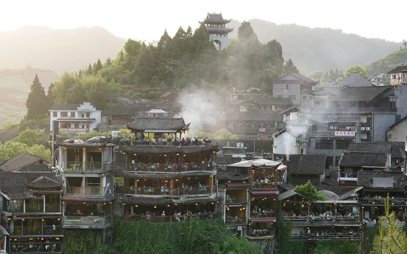 Traditional Tujia Diaojiaolou wooden stilt houses built along the mountain cliffs